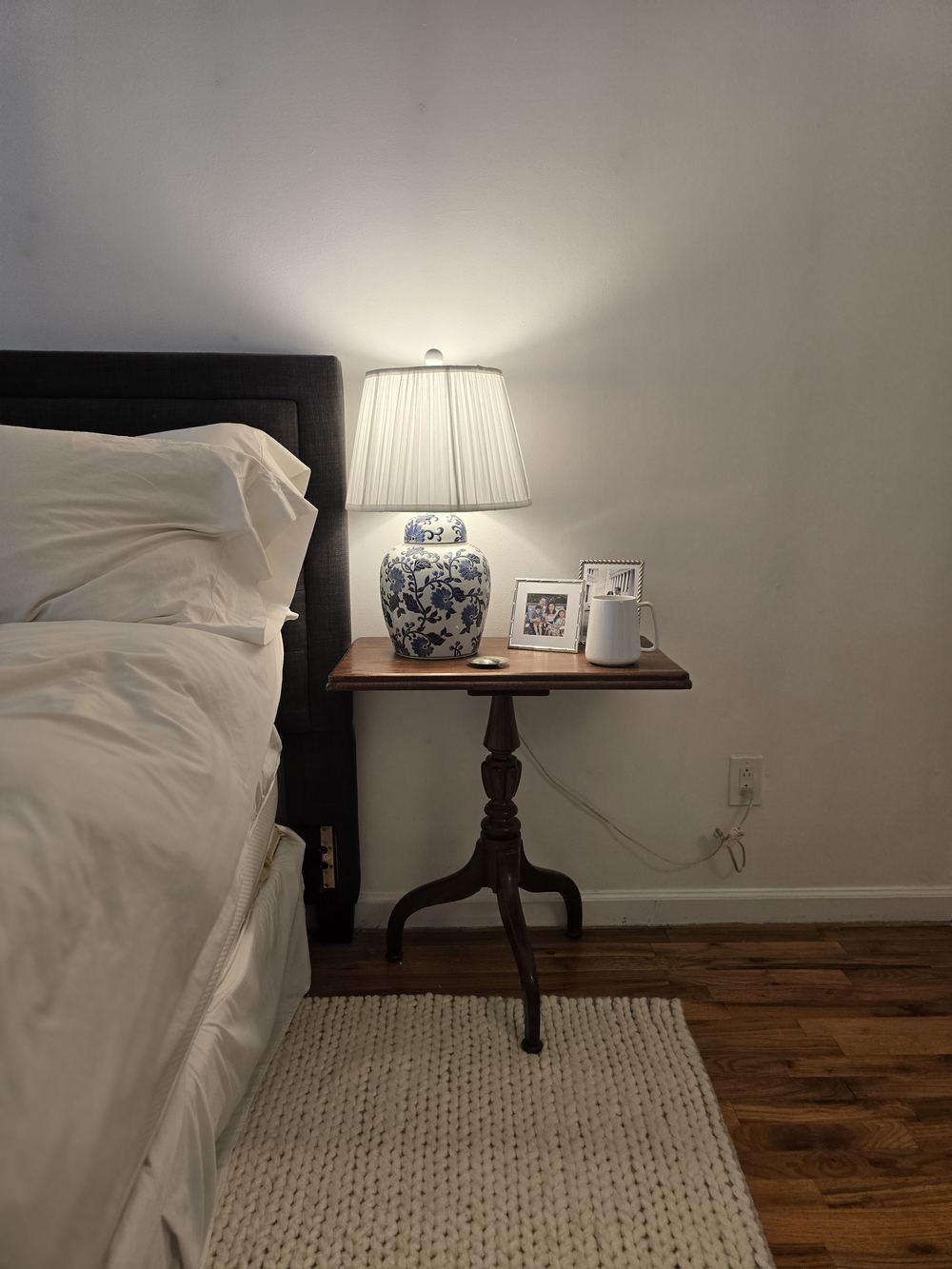A bedside table with a lamp in the Royal Penthouse